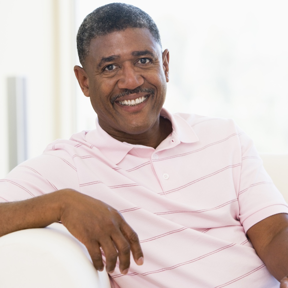 Man sat on a sofa reading a