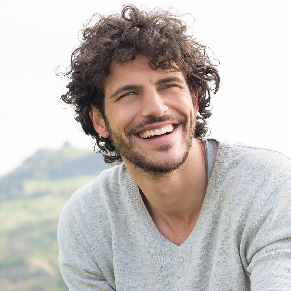 Portrait Of Young Handsome Man Smiling Outdoor