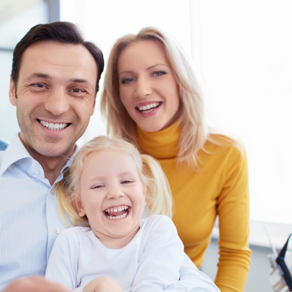 Smiling family in a dental clinic