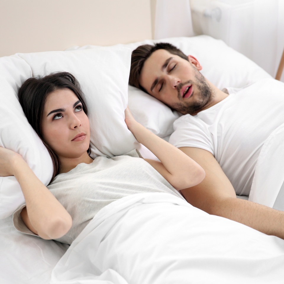 Young girl can't sleep because of her man's snoring.
