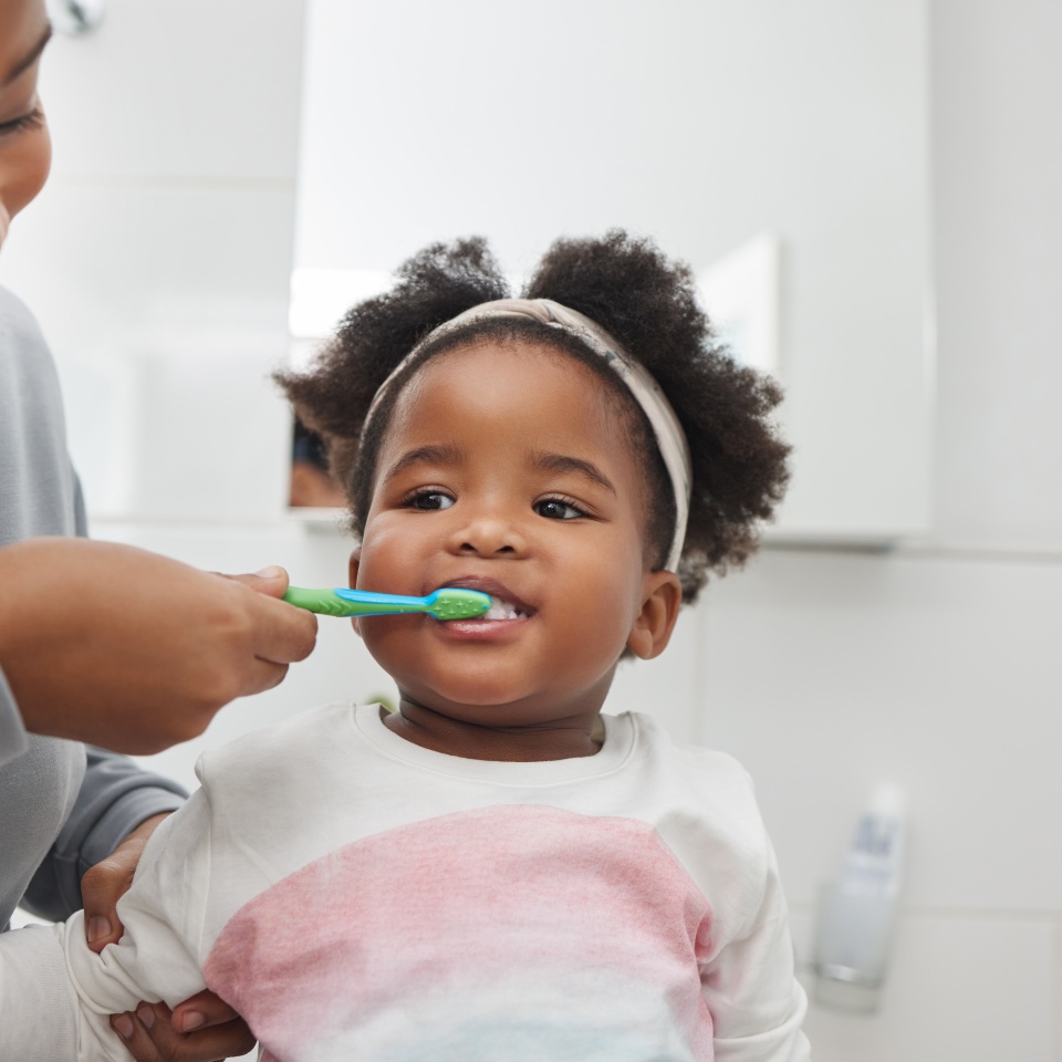 Mom will help her keep her baby teeth clean. Shot of a mother brushing her little daughters teeth in the bathroom at home.