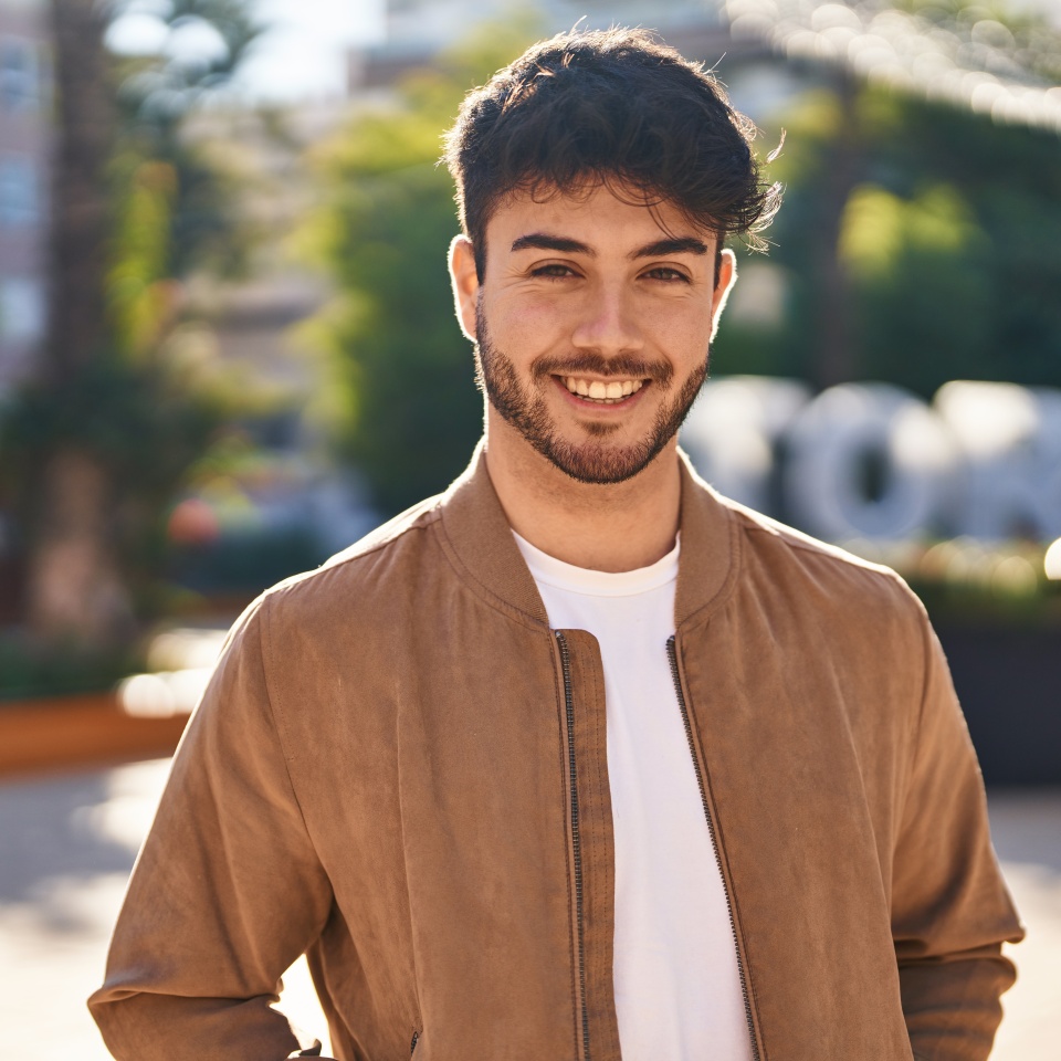 Young hispanic man smiling confident standing at park